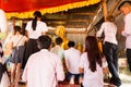 Image of people in buddhist temple paying respect to monks. Religious celebration. People serving rice to monks. Royalty Free Stock Photo