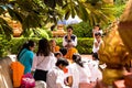 Image of people in buddhist temple paying respect to monks. Religious celebration. Royalty Free Stock Photo