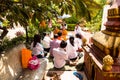 Image of people in buddhist temple paying respect to monks. Religious celebration. Royalty Free Stock Photo