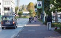 Image of people walking down the street side walk wearing face masks