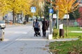 Image of people walking down the street side walk wearing face masks