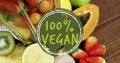 Image of 100 percent vegan text over fresh fruit Royalty Free Stock Photo
