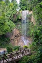 an image of a person on a bridge that is by some waterfall Royalty Free Stock Photo