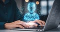 A person using a laptop with a futuristic digital interface and a glowing human silhouette. Royalty Free Stock Photo