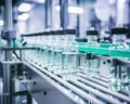 glass bottles with clear liquid on an automatic conveyor line.