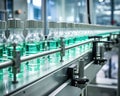 glass bottles with clear liquid on an automatic conveyor line.