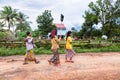 Image of Phnom Penh rural countryside. Rural scene of woman going to hospital with intravenous serum.