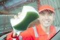 Image photo from inside the car cleaning guy car is cleaning the side glass with a foamy sponge Royalty Free Stock Photo