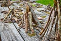 Picnic table wood covered in small stick teepee piles Royalty Free Stock Photo