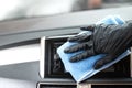 This image is a picture of wiping the car by a blue microfiber cloth with hand wearing gloves Royalty Free Stock Photo