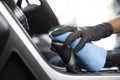 This image is a picture of wiping the car by a blue microfiber cloth with hand wearing gloves Royalty Free Stock Photo