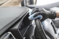 This image is a picture of wiping the car by a blue microfiber cloth with hand wearing gloves Royalty Free Stock Photo