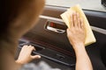 This image is a picture of wiping the car with a yellow microfiber cloth by hand. Royalty Free Stock Photo