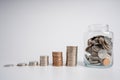 Image of pile of Thai baht coins and coins in a jar over white background. Finance and banking concept