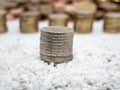 Image of pile of two Euro coins on white little stones close up Royalty Free Stock Photo