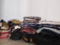 image of a pile of various clothes arranged on the floor without a wardrobe