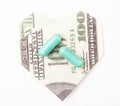 Image of pills origami money heart symbol white background Royalty Free Stock Photo