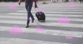 Image of pink digital clouds with numbers growing over man crossing street with suitcase in city