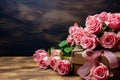 An image of pink and red roses in a beautiful box with a pink ribbon bow on the side.