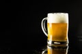 Image of pint glass tankard of foamy beer, with copy space on black background