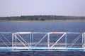 Image of a pipe line created in the middle of a blue lake
