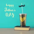 Image of plastic cup with golden heart. Father`s day concept. Royalty Free Stock Photo