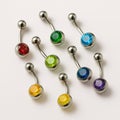 Curved belly button rings in various colors displayed on a white background. Royalty Free Stock Photo