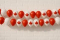 Celebratory decor featuring red and white balloons with maple leaf design for Canada Day festivities in a simple venue Royalty Free Stock Photo