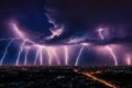 Lightning storm over city in purple light Royalty Free Stock Photo