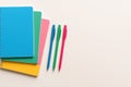 Colorful school supplies. notebooks and pens for academic tasks on light background Royalty Free Stock Photo