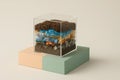 Layered Soil Cross-Section In Glass Box. Pollution Concept With Plastic Waste, Earth, Rocks And Environmental Message About Human Royalty Free Stock Photo