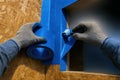 Hands Applying Blue Flashing Tape to Window, generative ai Royalty Free Stock Photo