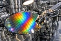 Robotic arm holding a colorful silicon wafer in a manufacturing plant Royalty Free Stock Photo