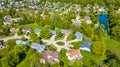 Pond in large overlook of suburban neighborhood homes and houses aerial Royalty Free Stock Photo