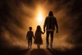parent and children silhouette walking towards the light. light in the end of the tunnel. hope concept. Royalty Free Stock Photo