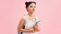 Image of positive asian student girl holding exercise books  over pink background Royalty Free Stock Photo