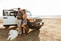 Loving couple with dog samoyed outdoors near car Royalty Free Stock Photo