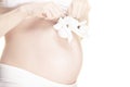 Image of pregnant woman baby shoes white background Royalty Free Stock Photo