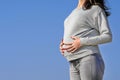 Image of pregnant woman touching her belly with hands. Closeup of unrecognizable pregnant woman with hands over tummy Royalty Free Stock Photo