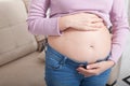 Image of pregnant woman touching her belly with hands at home. Copy space and mock up. Cropped image Royalty Free Stock Photo