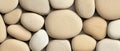 A collection of small, round, and smooth stones in various shades of beige and white. Royalty Free Stock Photo