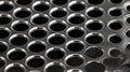 A close-up view of a metal mesh with numerous circular holes. Royalty Free Stock Photo