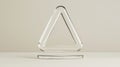 A transparent glass triangle with a white interior sits on a clear glass base. Royalty Free Stock Photo