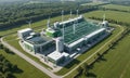aerial view large green and white industrial facility with multiple wind turbines, surrounded by grassy field Royalty Free Stock Photo