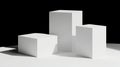 Three white cubes of varying heights stand on a white surface against a black background. Royalty Free Stock Photo