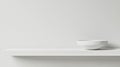 A minimalist white shelf with a white bowl on it. Royalty Free Stock Photo