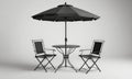black umbrella shades round table with two black folding chairs, set against white background. Royalty Free Stock Photo