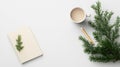 A white table with a notebook, mug, pencil, and pine branch. Royalty Free Stock Photo