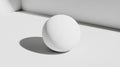 A white sphere sits on a white surface, casting a shadow to the left. Royalty Free Stock Photo