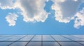 A blue sky with white clouds and a building with a grid pattern. Royalty Free Stock Photo